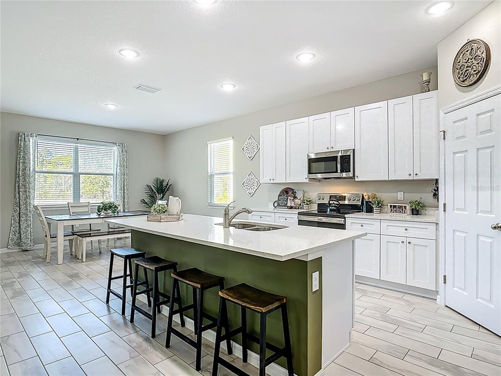39641 Royal Trails Road Eustis, FL 32736 - Photo 13 of 57 a kitchen with appliances a sink a counter top space and cabinets