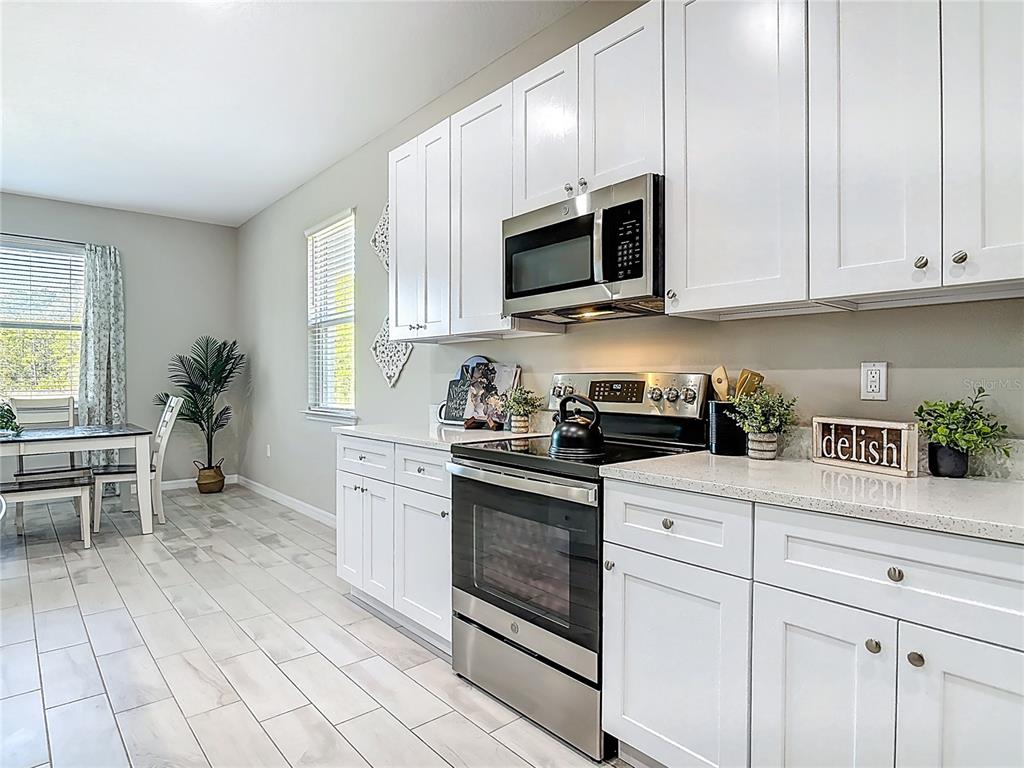 39641 Royal Trails Road Eustis, FL 32736 - Photo 15 of 57 a kitchen with white cabinets and appliances