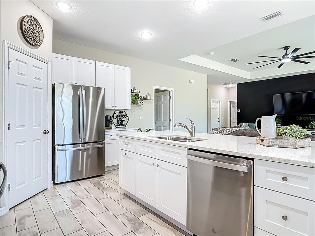 39641 Royal Trails Road Eustis, FL 32736 - Photo 18 of 63 a kitchen with stainless steel appliances granite countertop a refrigerator and a sink