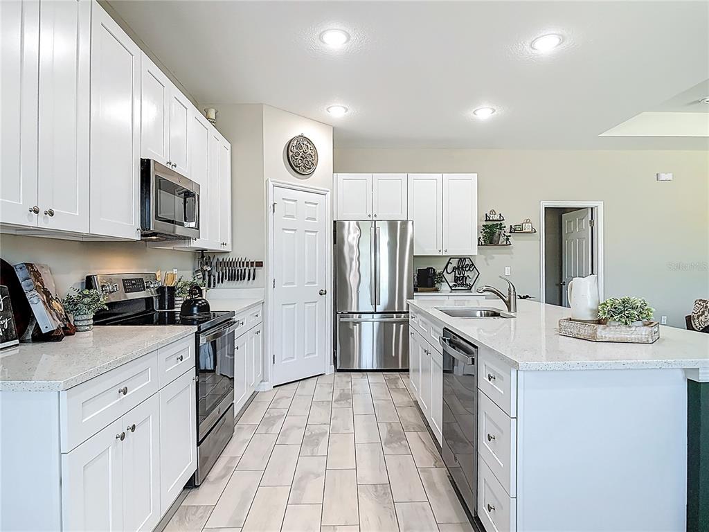 39641 Royal Trails Road Eustis, FL 32736 - Photo 18 of 57 a kitchen with white cabinets and stainless steel appliances