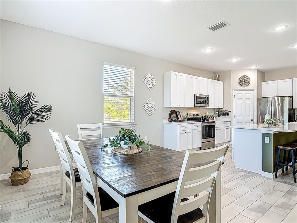 39641 Royal Trails Road Eustis, FL 32736 - Photo 24 of 57 a kitchen with granite countertop white cabinets and stainless steel appliances