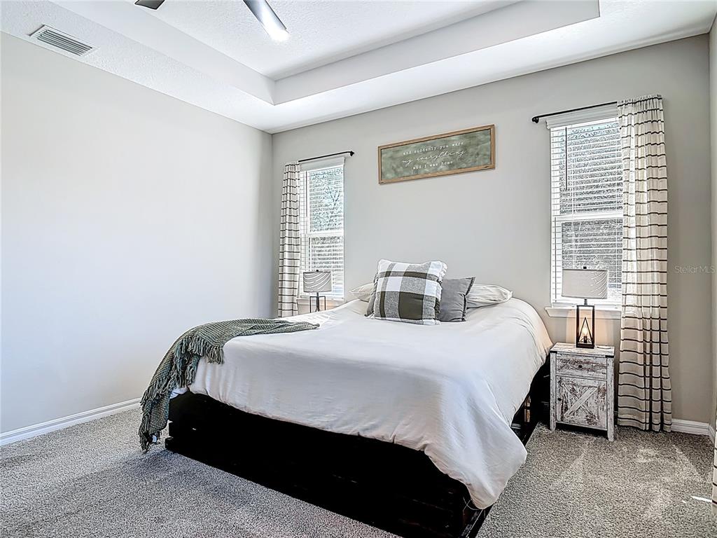 39641 Royal Trails Road Eustis, FL 32736 - Photo 25 of 63 a bedroom with a bed lamp and a window