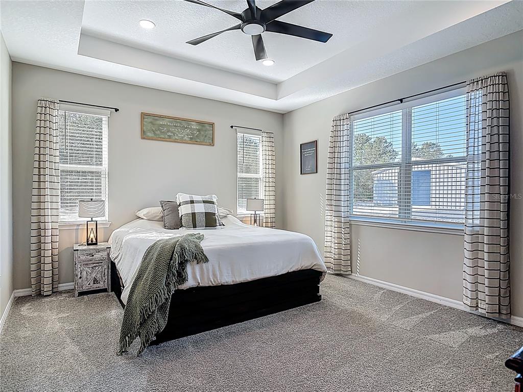 39641 Royal Trails Road Eustis, FL 32736 - Photo 25 of 57 a spacious bedroom with a bed and a large window
