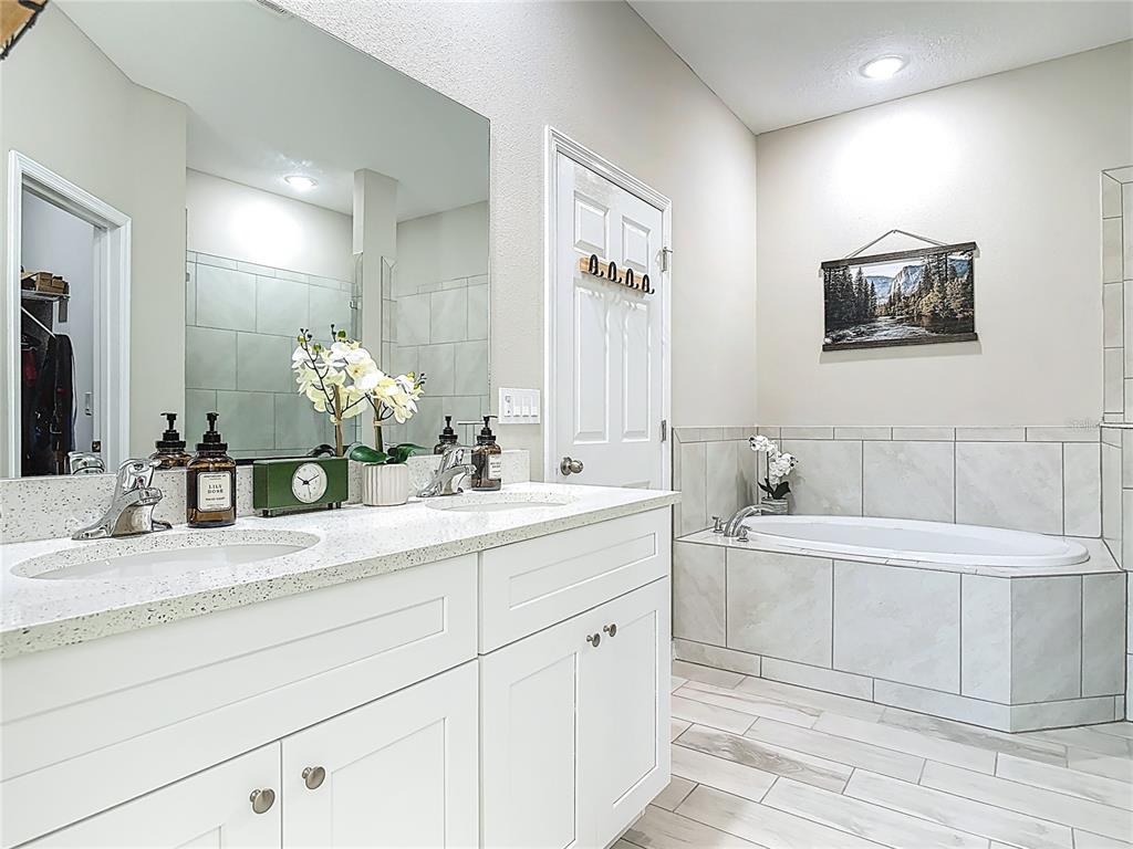 39641 Royal Trails Road Eustis, FL 32736 - Photo 30 of 57 a bathroom with a double vanity sink mirror and bathtub