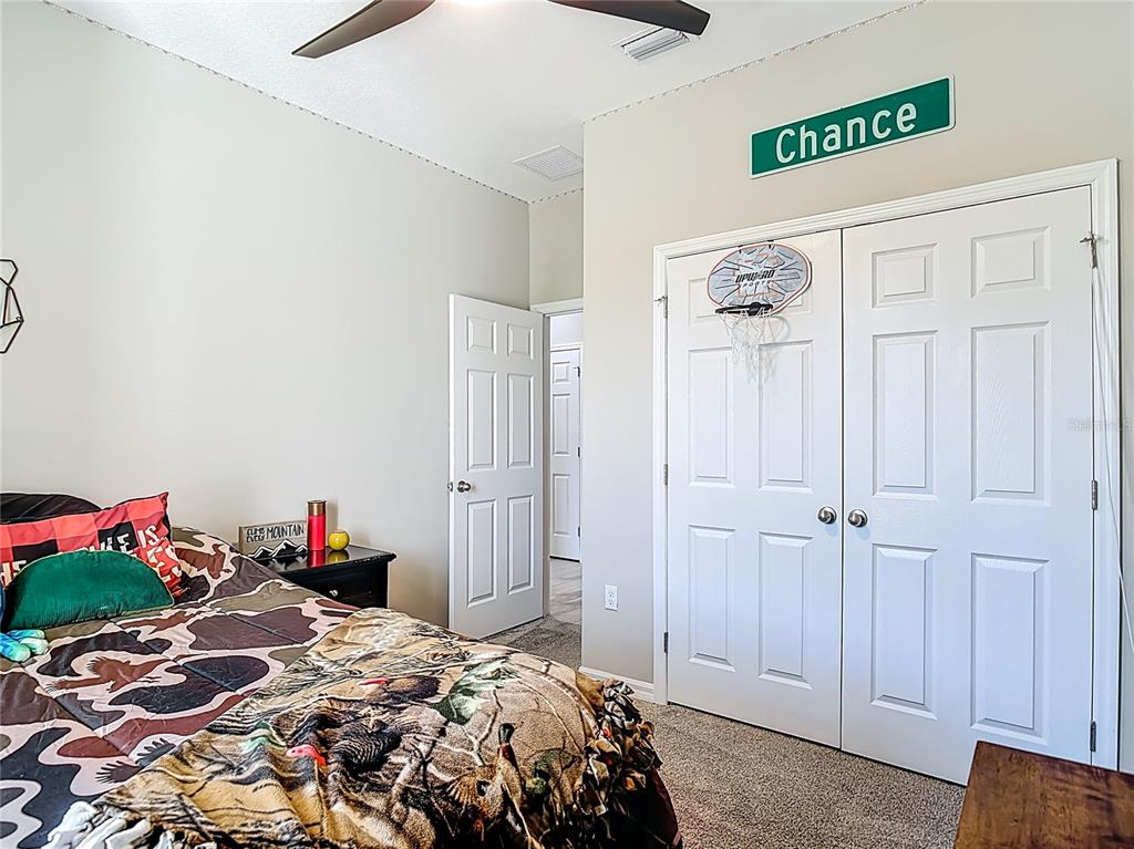 39641 Royal Trails Road Eustis, FL 32736 - Photo 35 of 63 a bedroom that has a bed and a closet in it