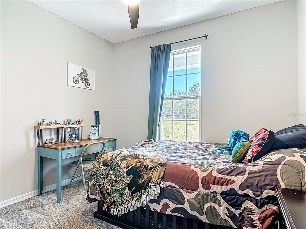 39641 Royal Trails Road Eustis, FL 32736 - Photo 37 of 63 a bedroom with a bed and a window