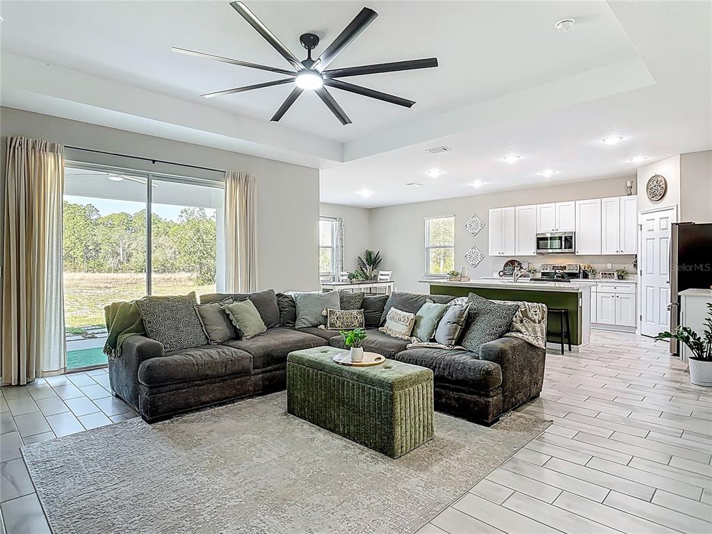 39641 Royal Trails Road Eustis, FL 32736 - Photo 9 of 57 a living room with furniture and a large window with kitchen view