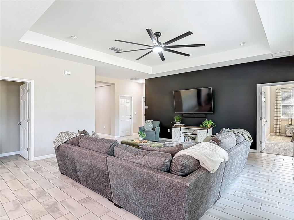39641 Royal Trails Road Eustis, FL 32736 - Photo 10 of 63 a living room with furniture and a flat screen tv