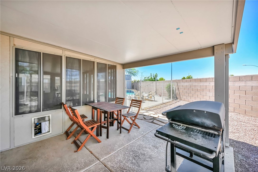 1234 Sunfire Street Henderson, NV 89014 - Photo 27 of 40 A spacious covered patio invites al fresco dining and overlooks a sparkling pool, perfect for entertaining.