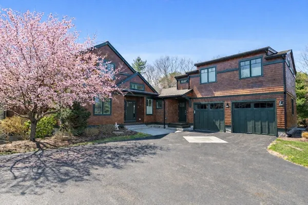 a front view of a house with a garden