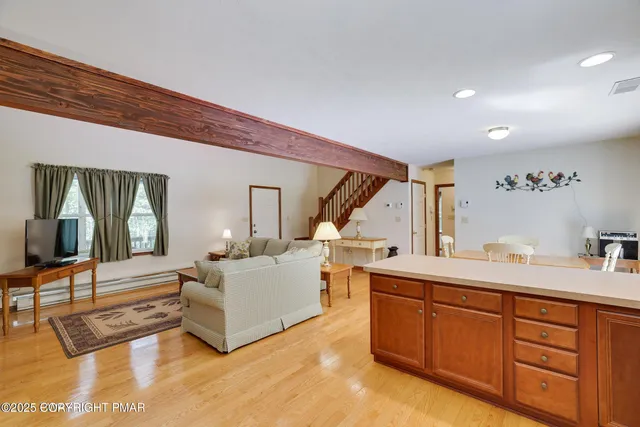 a utility room with stainless steel appliances granite countertop a refrigerator and a stove