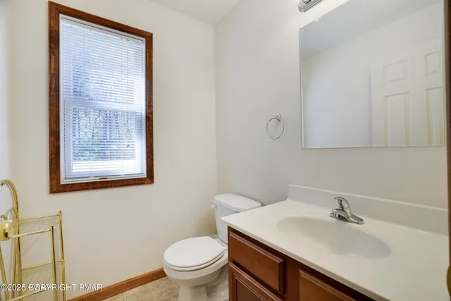 a living room with furniture and a dining table