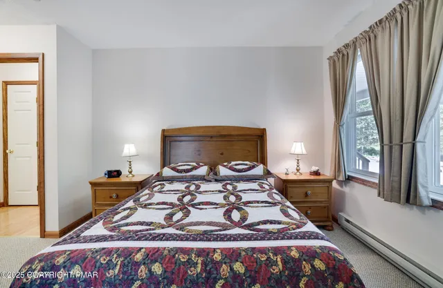 a bedroom with a bed next to a window