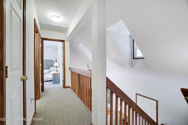 a living room with a bed furniture and a wooden floor