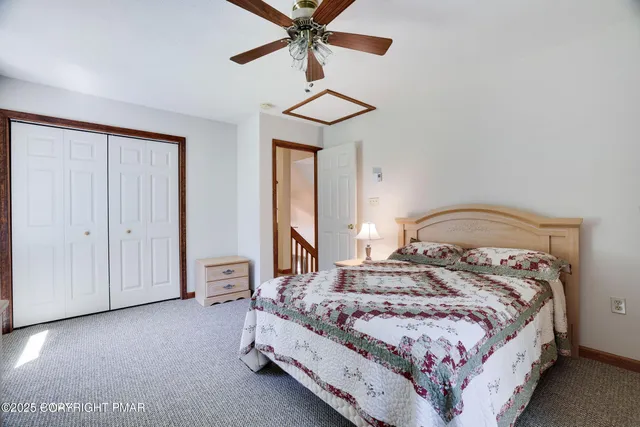 a bedroom with a bed and a lamp on dresser