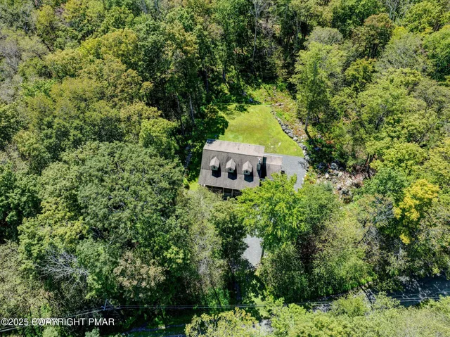 an aerial view of a house with a yard