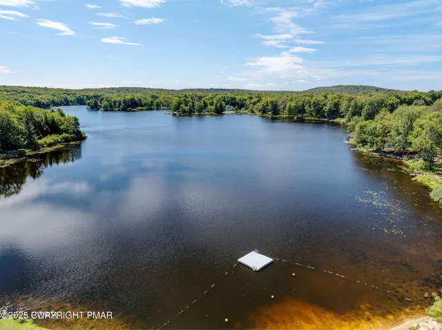 an aerial view of a houses with ocean view