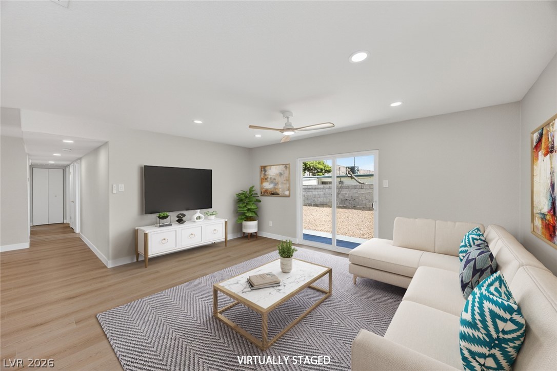 2484 Anglia Street Las Vegas, NV 89142 - Photo 9 of 20 Bright and airy living room with a sliding door leading to the outdoor area.