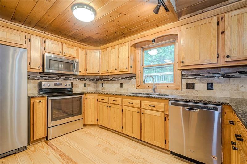 213 Moonshine Hollow Blue Ridge, GA 30513 - Photo 11 of 41 a kitchen with stainless steel appliances granite countertop a stove a sink and a microwave