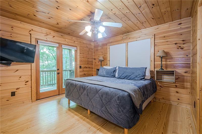 213 Moonshine Hollow Blue Ridge, GA 30513 - Photo 13 of 41 a spacious bedroom with a bed and a flat screen tv