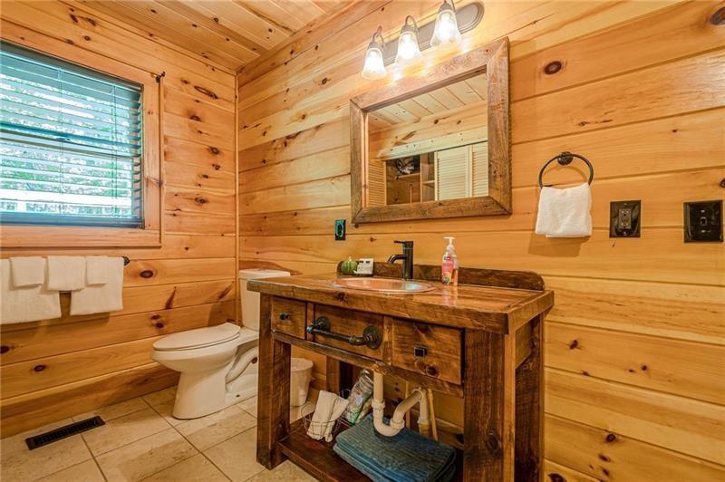 213 Moonshine Hollow Blue Ridge, GA 30513 - Photo 15 of 41 a bathroom with a sink a toilet and mirror