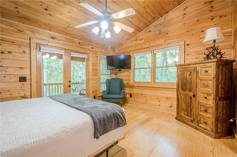 213 Moonshine Hollow Blue Ridge, GA 30513 - Photo 16 of 41 a bed room with a bed and a television