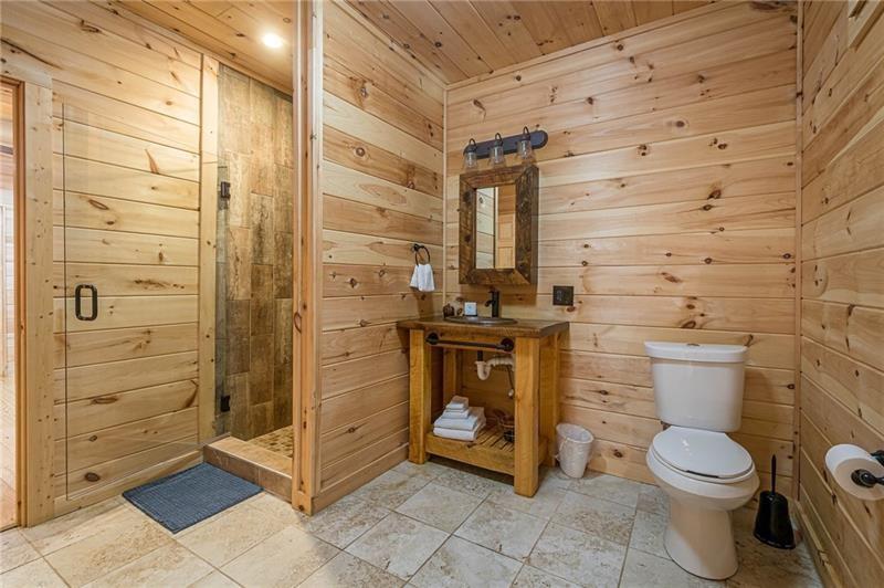 213 Moonshine Hollow Blue Ridge, GA 30513 - Photo 26 of 41 a bathroom with a toilet and a shower
