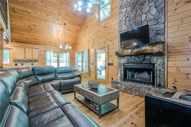 213 Moonshine Hollow Blue Ridge, GA 30513 - Photo 5 of 41 a living room with furniture a flat screen tv and a fireplace