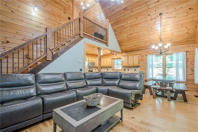 213 Moonshine Hollow Blue Ridge, GA 30513 - Photo 6 of 41 a living room with furniture and a chandelier