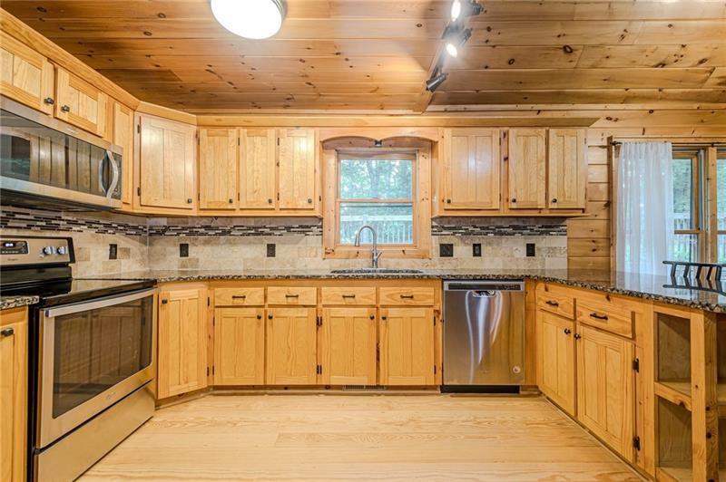213 Moonshine Hollow Blue Ridge, GA 30513 - Photo 9 of 41 a kitchen with stainless steel appliances granite countertop a stove a sink and a refrigerator