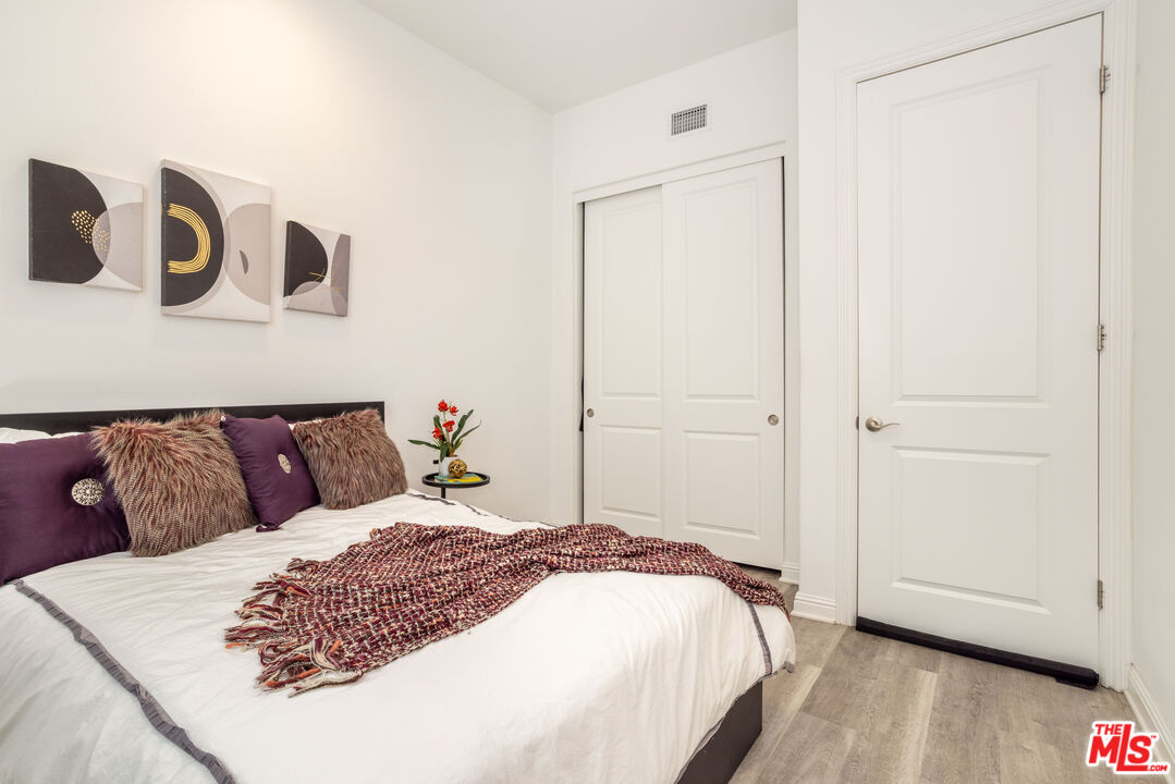 20621 West Chestnut Circle Porter Ranch, CA 91326 - Photo 14 of 30 a bedroom with a bed and wooden floor