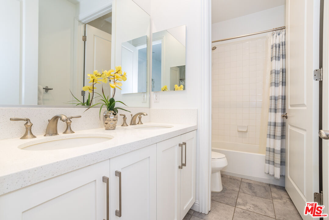 20621 West Chestnut Circle Porter Ranch, CA 91326 - Photo 19 of 30 a bathroom with a sink toilet double vanity and shower