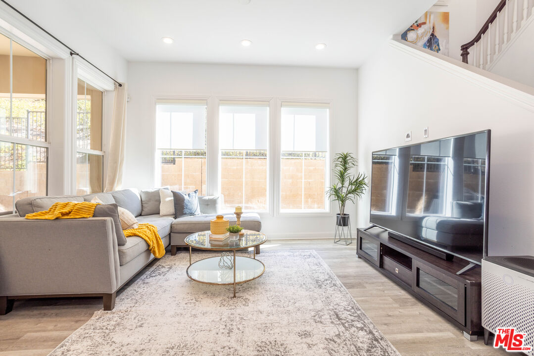 20621 West Chestnut Circle Porter Ranch, CA 91326 - Photo 2 of 30 a living room with furniture and floor to ceiling windows