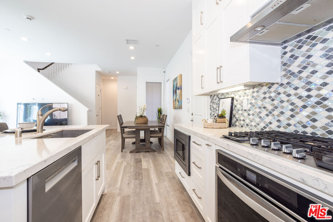20621 West Chestnut Circle Porter Ranch, CA 91326 - Photo 6 of 30 a kitchen with a sink stove and cabinets