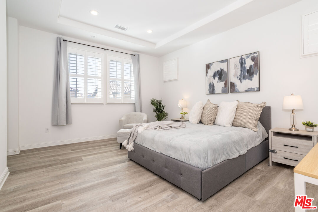 20621 West Chestnut Circle Porter Ranch, CA 91326 - Photo 10 of 30 a large bedroom with a bed and window