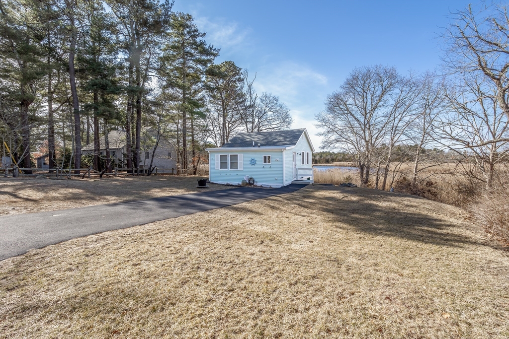 1 Ladd Avenue Wareham, MA 02571 - Photo 26 of 26 a view of a grey house with a snow on the road