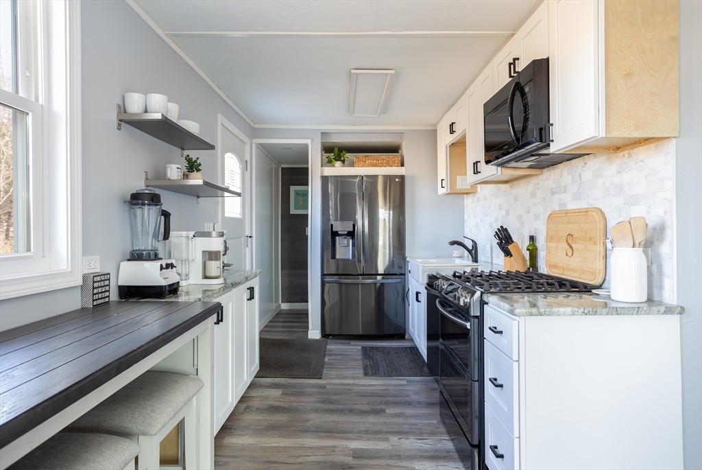 1 Ladd Avenue Wareham, MA 02571 - Photo 4 of 26 a kitchen with stainless steel appliances granite countertop a stove and a refrigerator