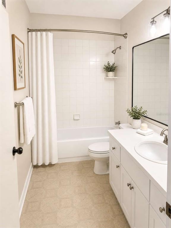 5122 Northridge Road, Unit 102 Sarasota, FL 34238 - Photo 6 of 14 a bathroom with a double vanity sink toilet and shower