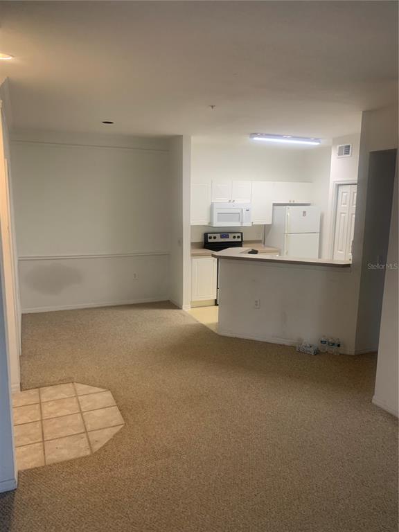 5122 Northridge Road, Unit 102 Sarasota, FL 34238 - Photo 7 of 12 a kitchen with stainless steel appliances a stove and a refrigerator