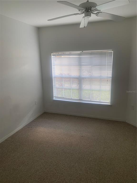 5122 Northridge Road, Unit 102 Sarasota, FL 34238 - Photo 9 of 12 an empty room with a empty space and windows