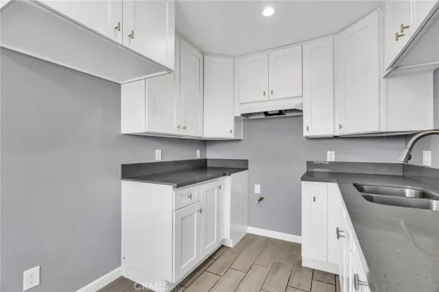 a kitchen with a sink cabinets and appliances