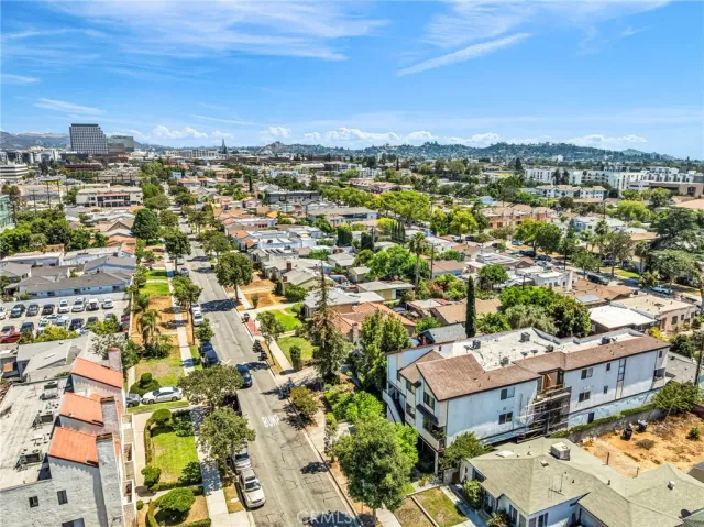 an aerial view of residential houses with city view