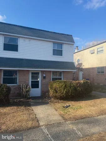 a front view of a house with sitting area