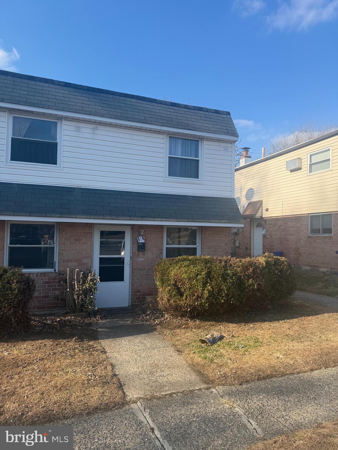 a front view of a house with sitting area