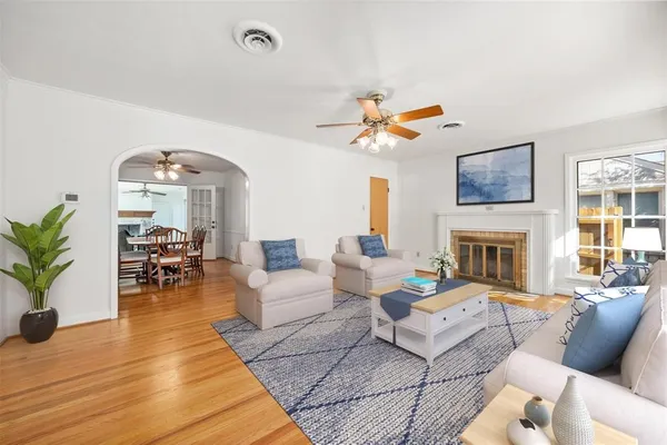 a living room with furniture a fireplace and a flat screen tv