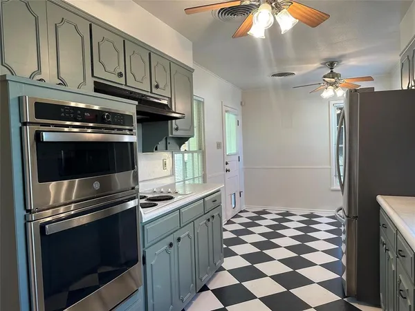a kitchen with granite countertop stainless steel appliances and cabinets