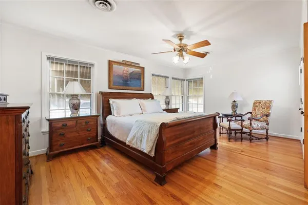 a bedroom with a bed and wooden floor