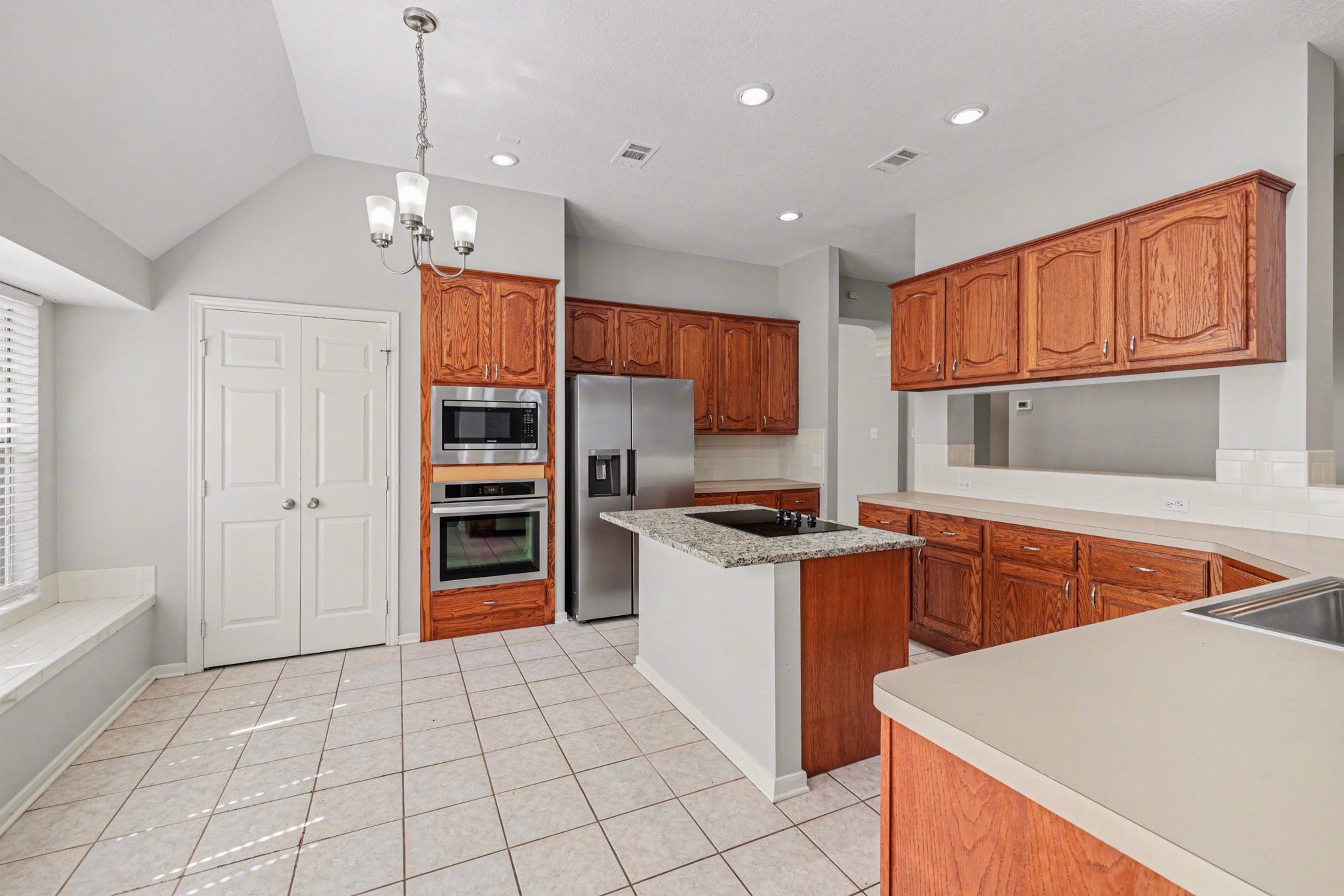 215 Bristol Bend Circle Spring, TX 77382 - Photo 8 of 25 a kitchen with stainless steel appliances granite countertop a refrigerator a sink dishwasher a stove and white countertops with wooden floor