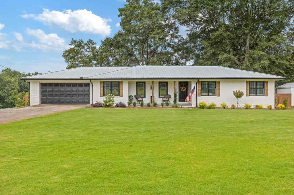 a front view of house with yard and green space