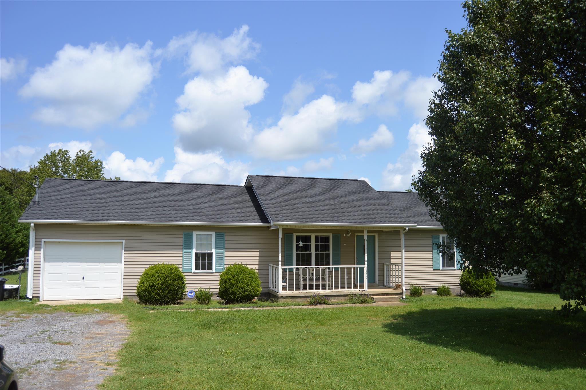 1529 Longview Road Unionville, TN 37180 - Photo 1 of 21 a front view of a house with a garden and yard